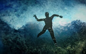 Silhouette d'un homme qui tombe avec en fond un paysage de montagne